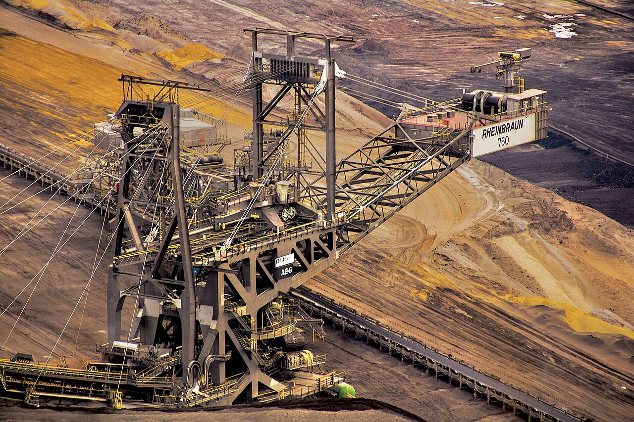 The Garzweiler lignite mine in Germany, a vast stepped pit with a large stacker machine.
