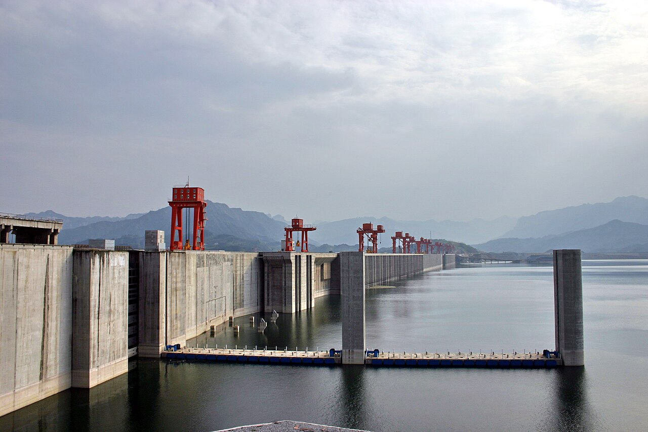 The Three Gorges Dam spanning the Yangtze, with ship locks and a wide reservoir.