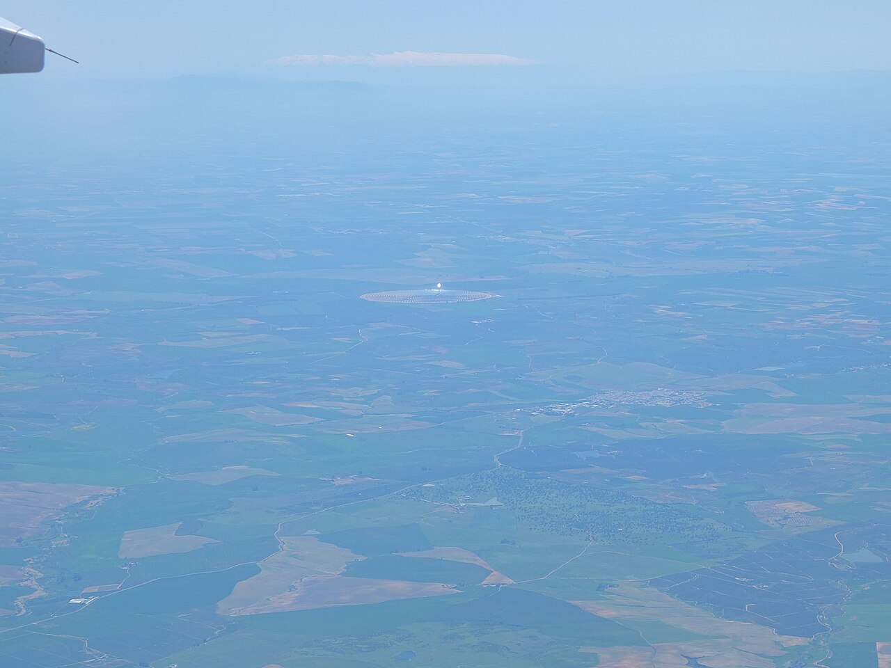 Aerial view of Gemasolar, a solar tower surrounded by a ring of mirrors in Andalusia.